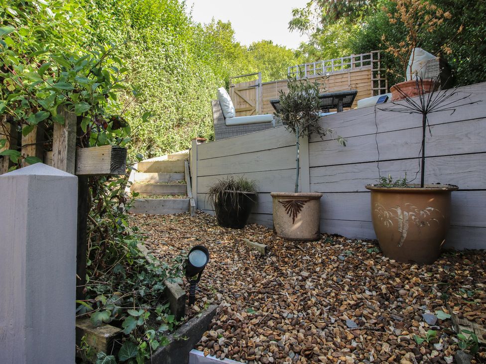 A garden with steps leading up to seating area at 8 Welsh Street Bishop's Castle