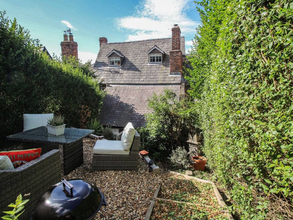 A garden with seating and gravel path at 8 Welsh Street Bishop's Castle