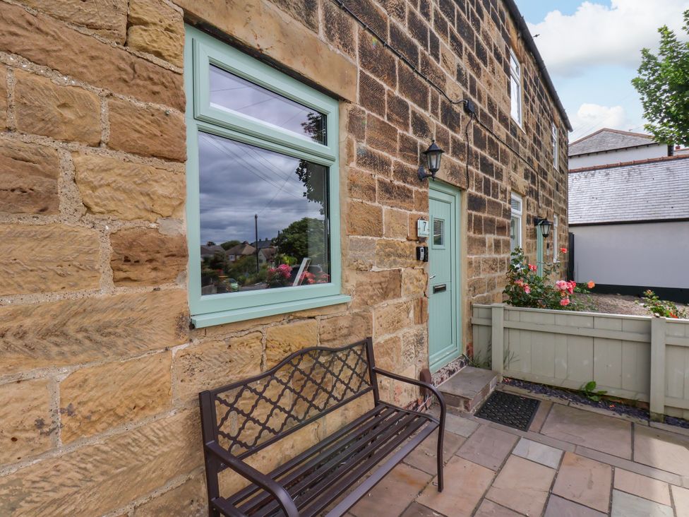 An outdoor area with a bench and flowers at 7 St. Germains Lane