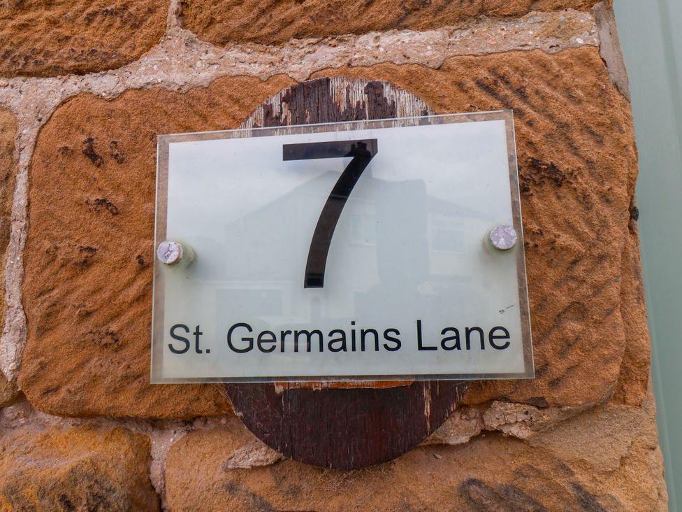House number sign for 7 St. Germains Lane on a stone wall