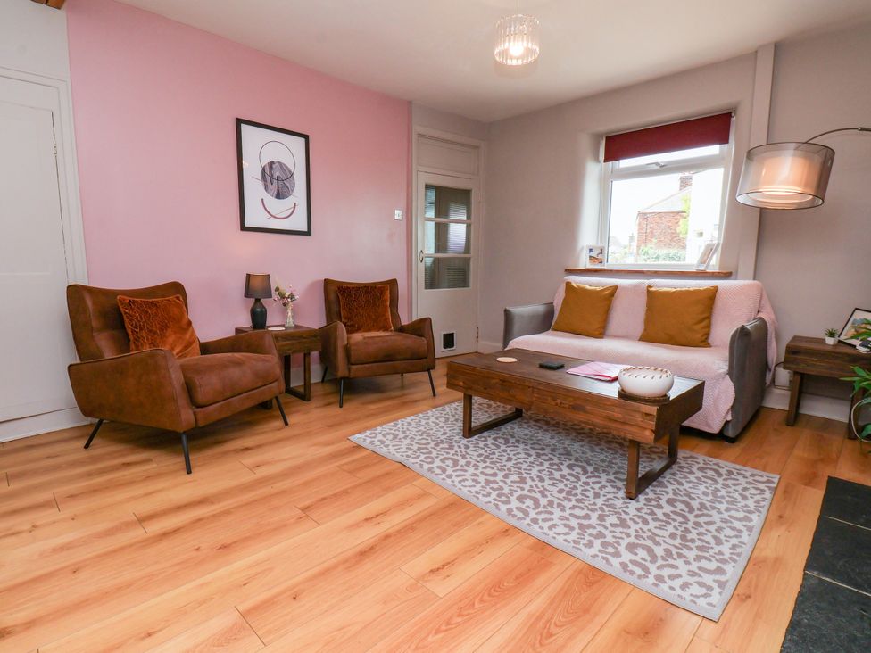 A living room with a sofa and two armchairs at 7 St. Germains Lane