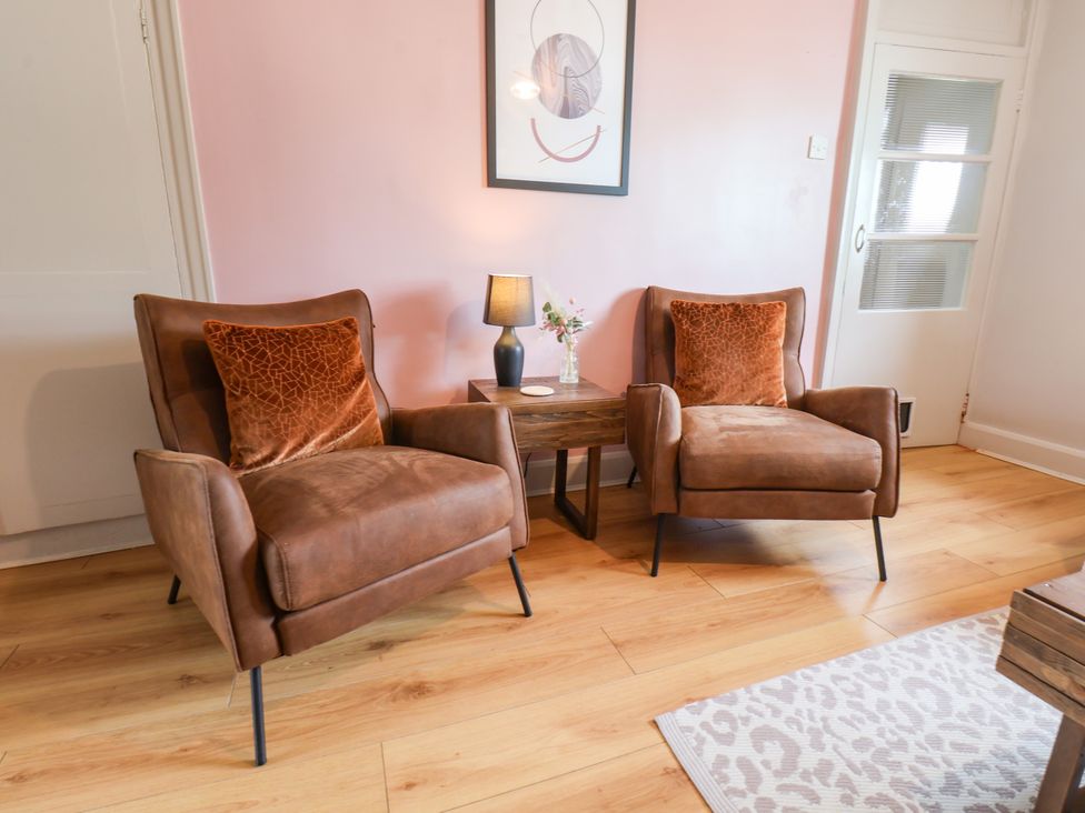 A living room with two armchairs and a side table at 7 St. Germains Lane