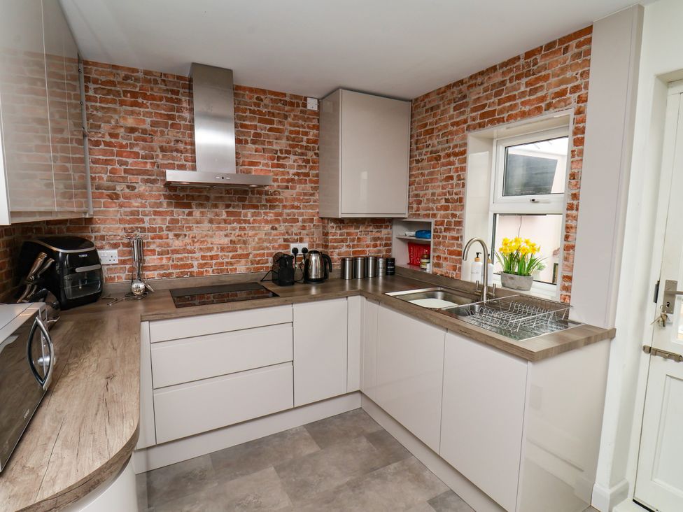 A kitchen with a sink and stove at 7 St. Germains Lane