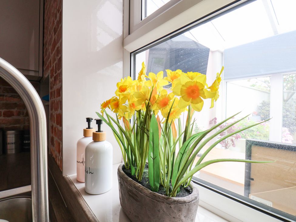 Flowers in a vase on a kitchen countertop at 7 St. Germains Lane
