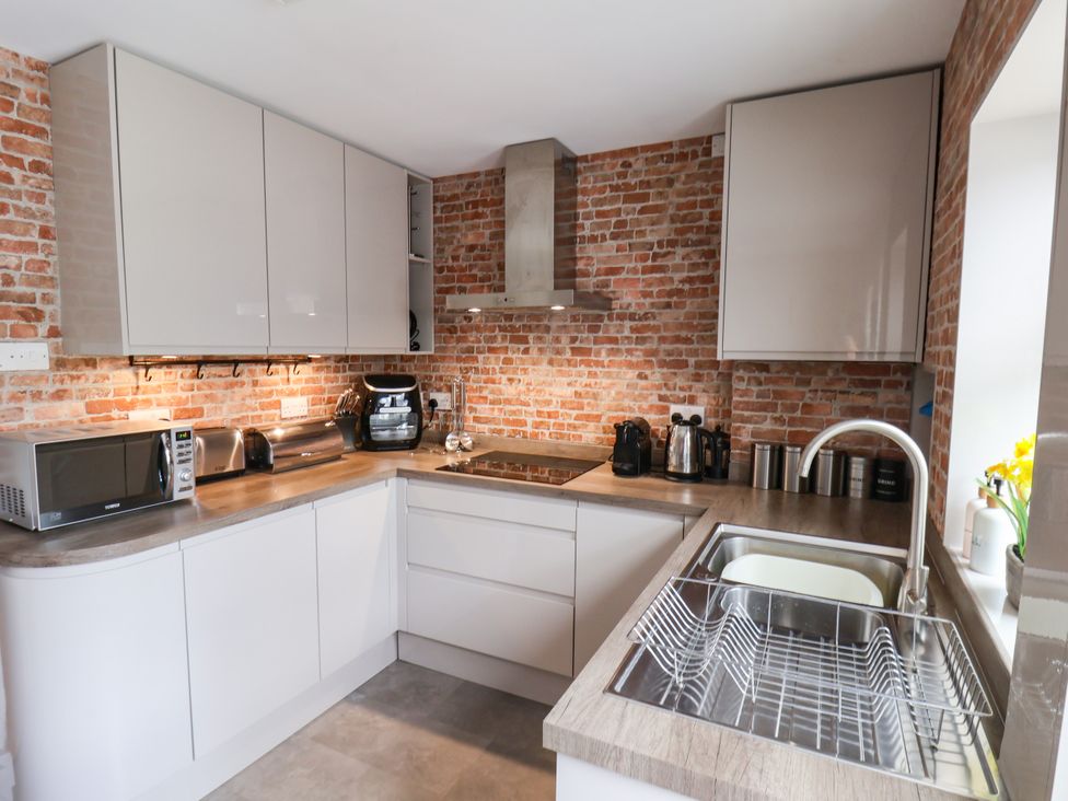 A kitchen with appliances and a sink at 7 St. Germains Lane