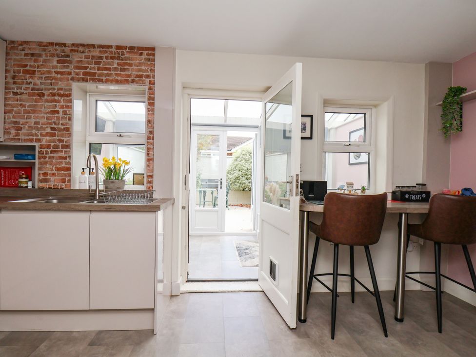 A kitchen with a counter and bar stools at 7 St. Germains Lane