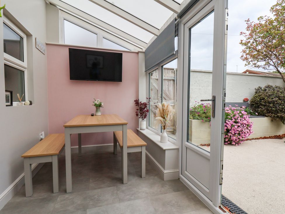 A conservatory with a table and benches at 7 St. Germains Lane
