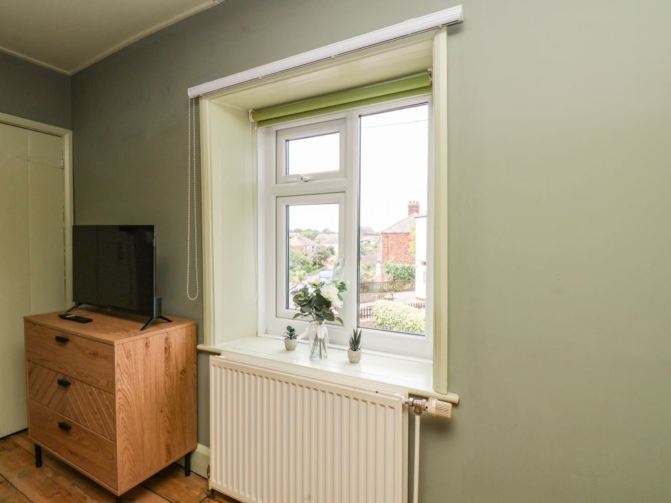 A chest of drawers and a tv in a bedroom at 7 St. Germains Lane