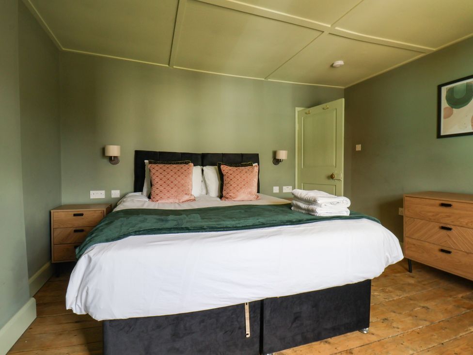 A bedroom with a bed and nightstands at 7 St. Germains Lane