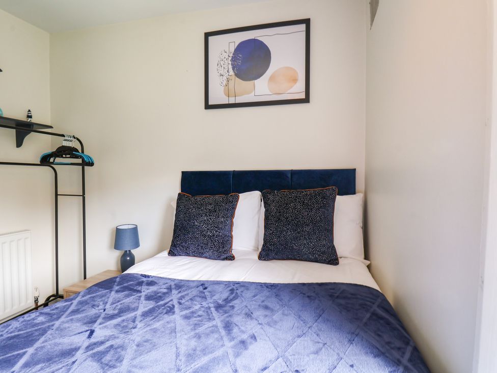 A bedroom with a bed and wall art at 7 St. Germains Lane