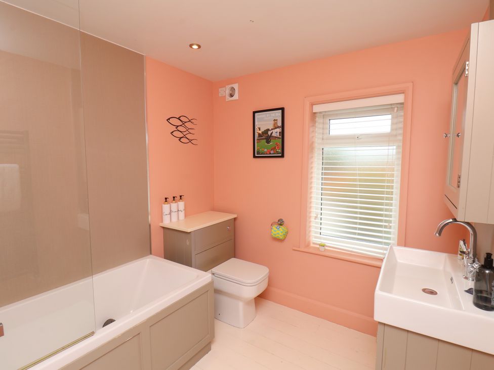A bathroom with a bathtub, toilet, and sink at 7 St. Germains Lane 