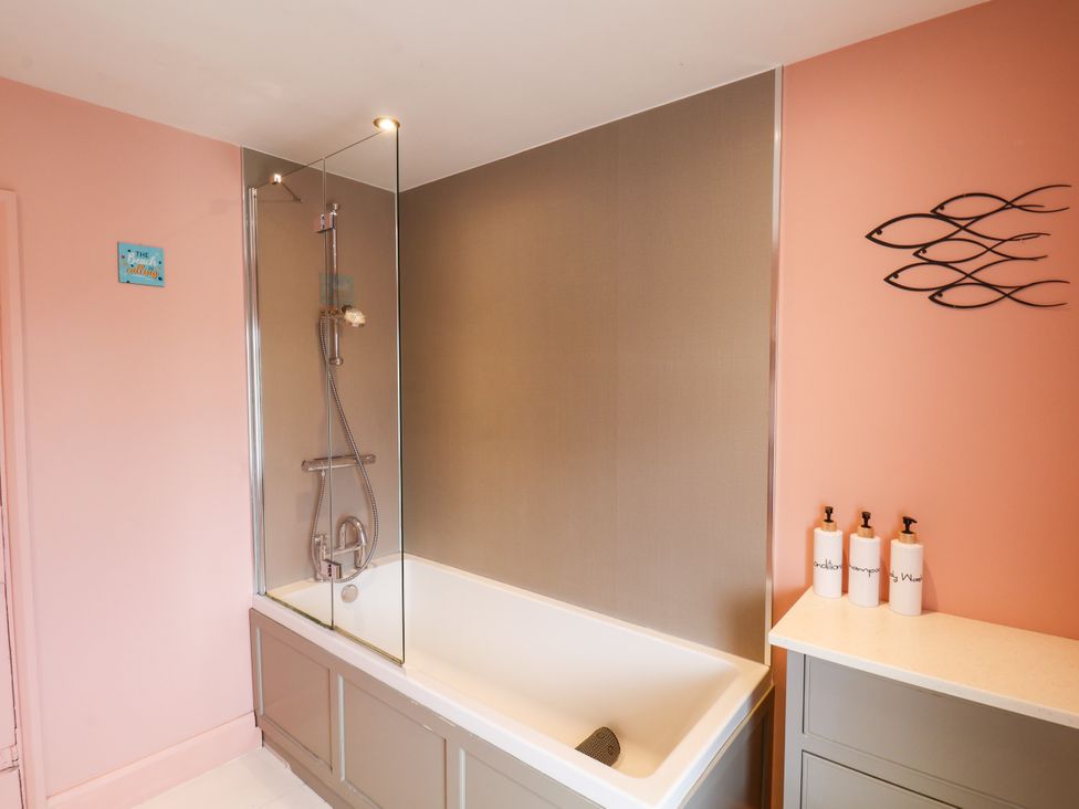 A bathroom with a bath tub and shower at 7 St. Germains Lane