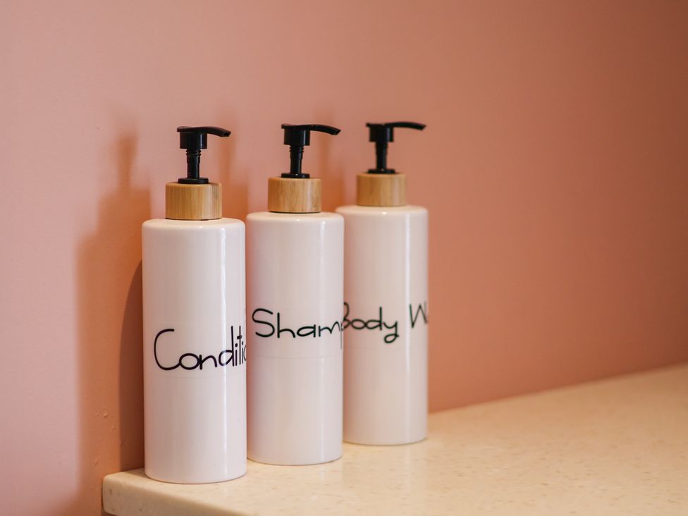 Three bottles of conditioner, shampoo, and body wash at 7 St. Germains Lane