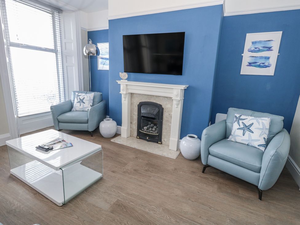 A living room with a television and fireplace at Vista Mare 1 Weymouth