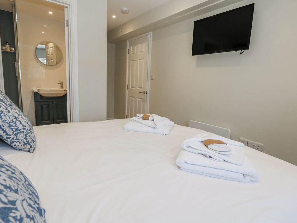 A bedroom with a bed and television at Vista Mare 1 Weymouth