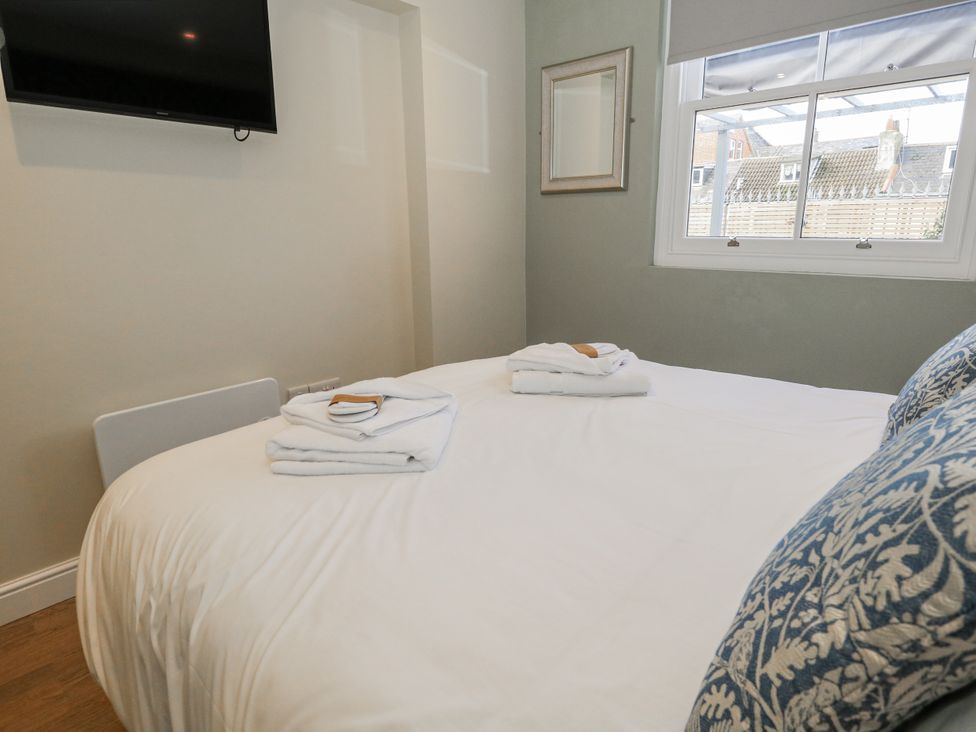 A bedroom with a bed and towels at Vista Mare 1 Weymouth