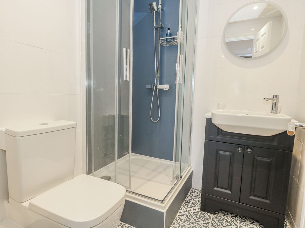 A bathroom with a shower and vanity at Vista Mare 1 Weymouth