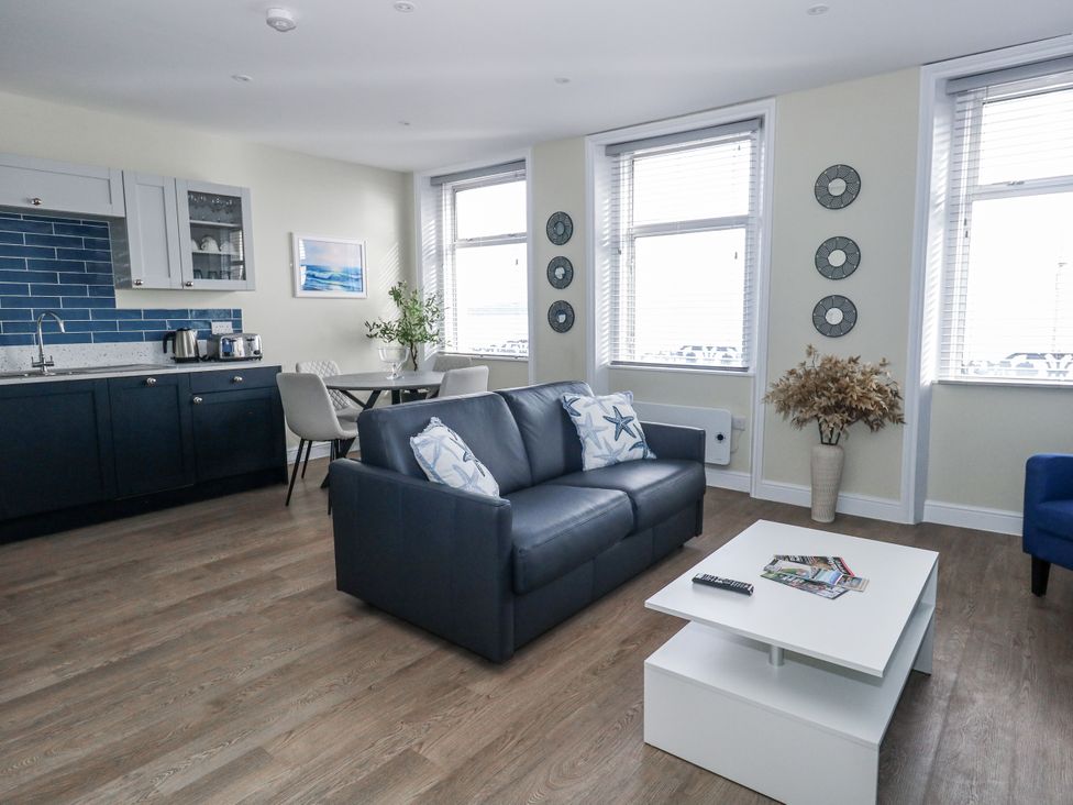 A living room with a sofa and coffee table at Vista Mare 2 in Weymouth