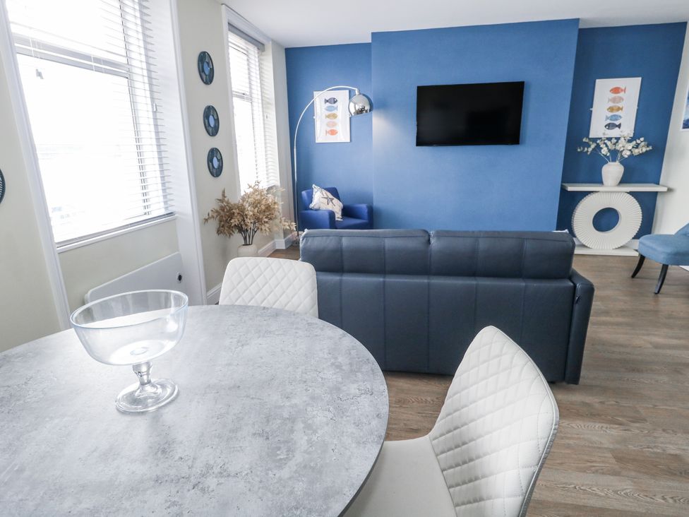 A living room with a sofa and television at Vista Mare 2 in Weymouth