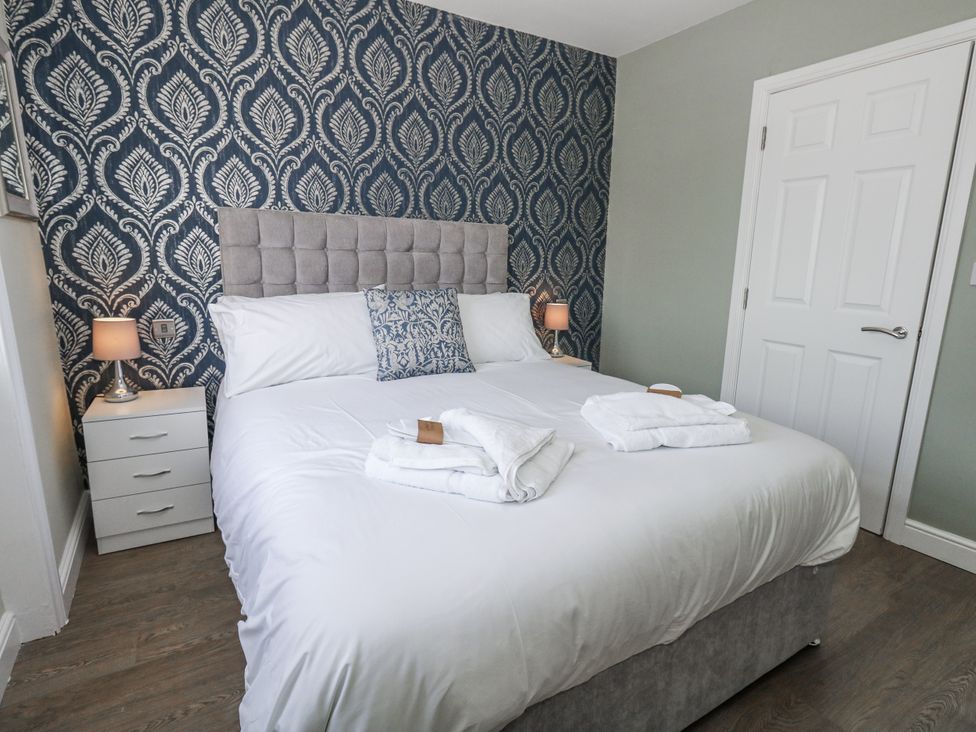 A bedroom with a bed and nightstand at Vista Mare 2 Weymouth