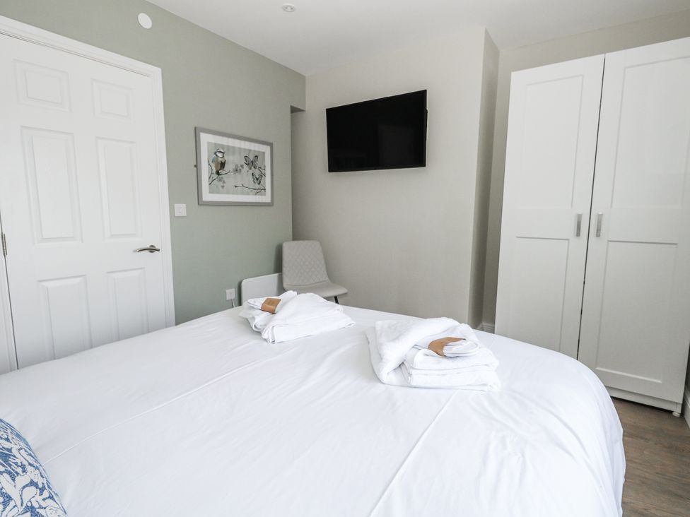 A bedroom with a bed and television at Vista Mare 2 in Weymouth