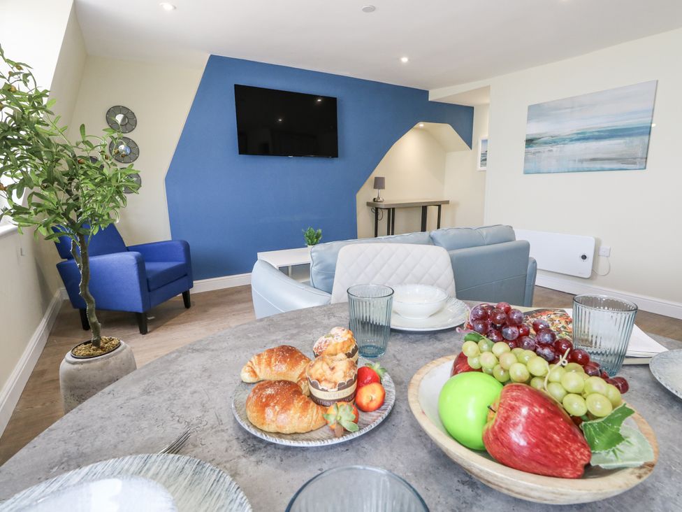 A dining room with table and fruit at Apartment 3 in Weymouth