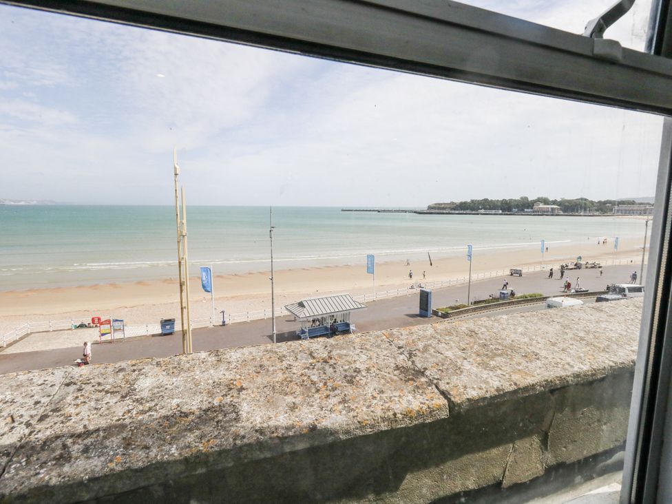 A view of the sea and beach from a window at Apartment 3 in Weymouth