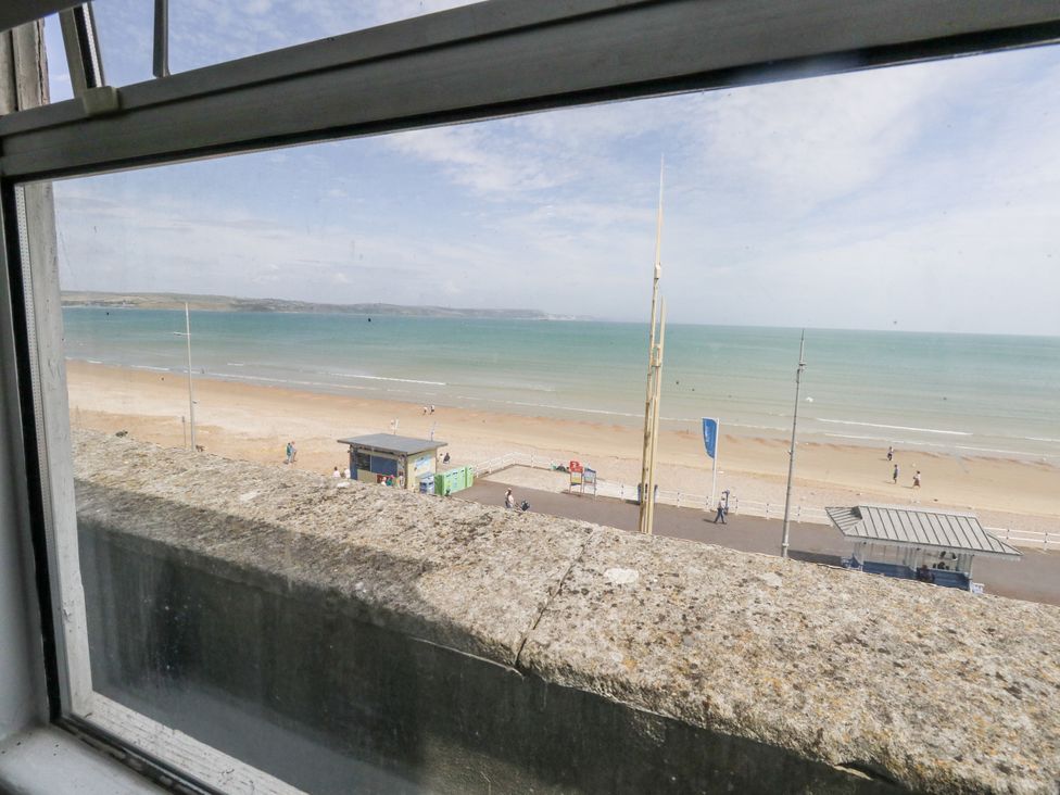 A view of the beach and sea from a window at Apartment 3 in Weymouth
