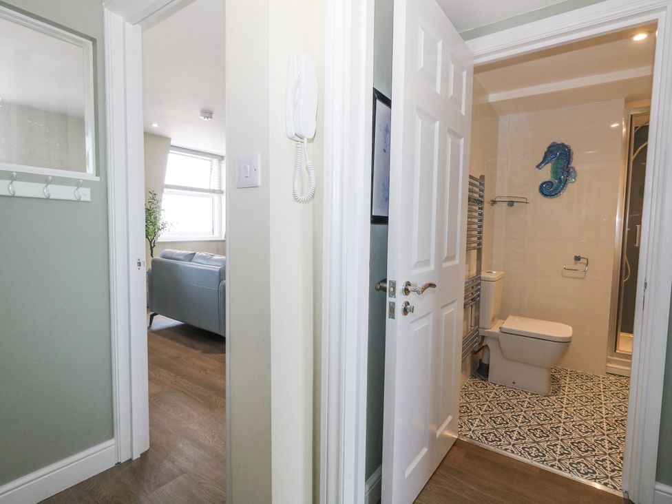 A bathroom with a toilet and sink at Apartment 3 Weymouth