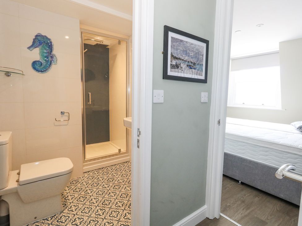 A bathroom with shower and toilet at Apartment 3 in Weymouth
