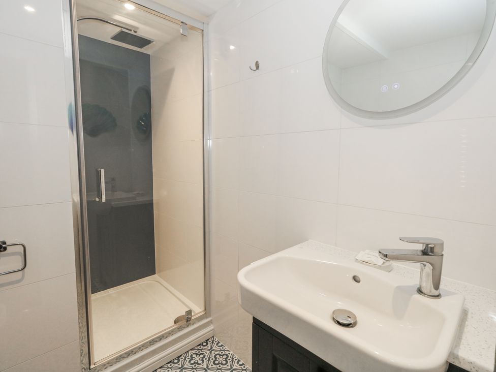 A bathroom with a shower and sink at Vista Mare 3 Weymouth