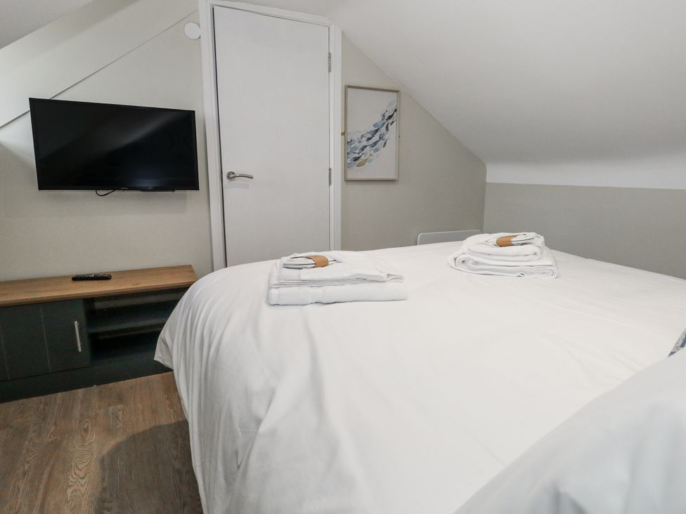 A bedroom with a bed and television at Vista Mare 3 in Weymouth