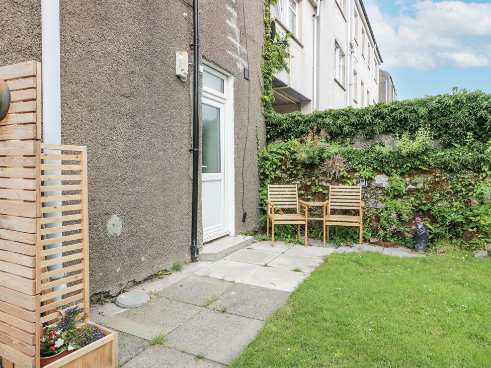 A garden with chairs and flowers at 8 George Street, Millport