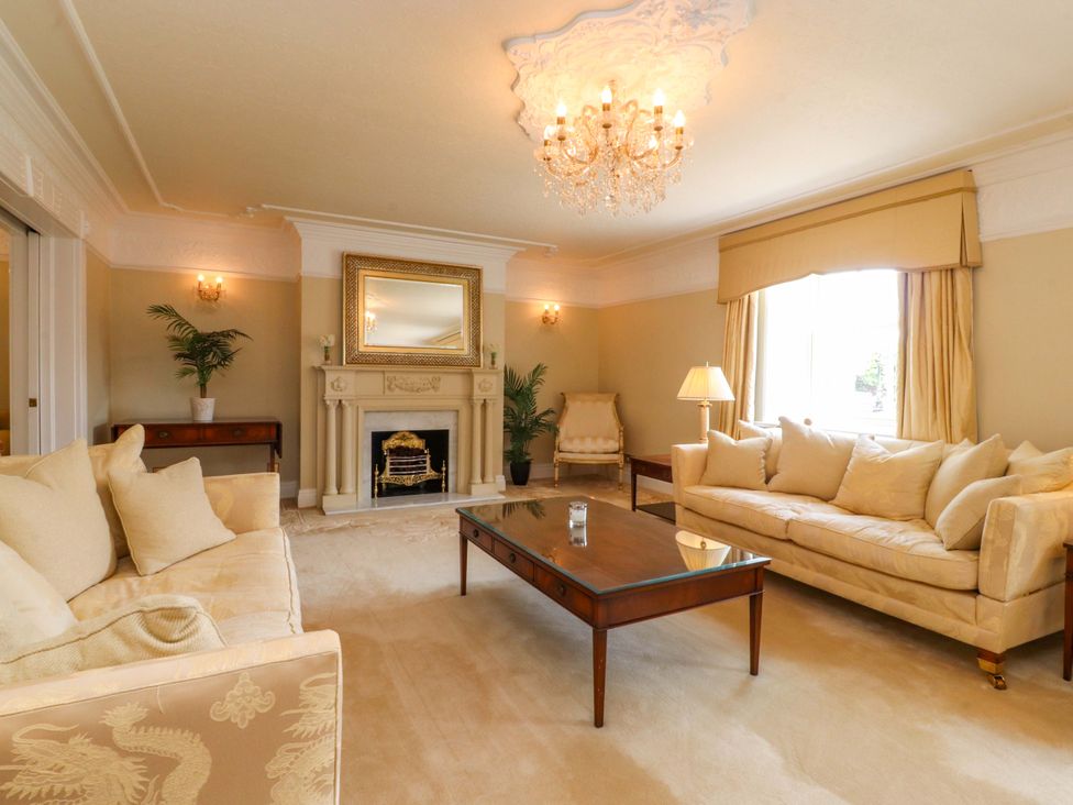 A living room with a coffee table and a fireplace at Laithe House in Burnley