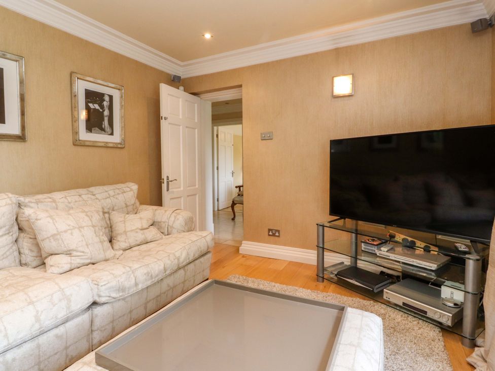 A living room with a sofa and television at Laithe House Burnley