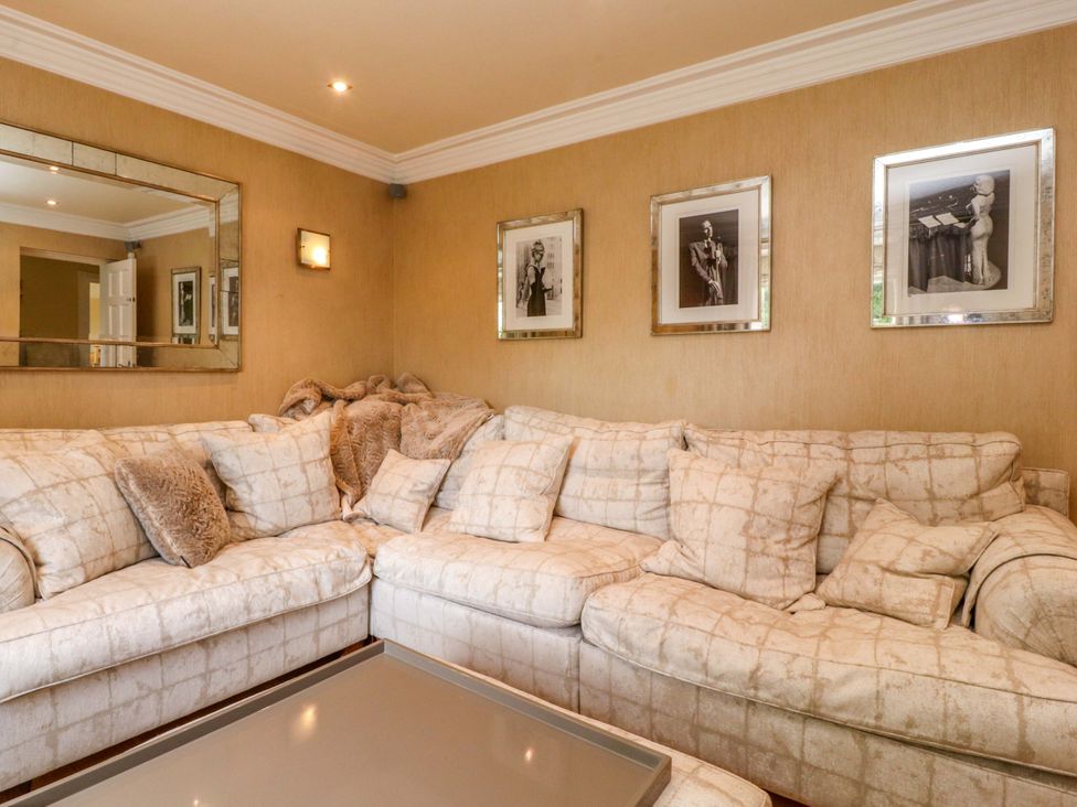 A living room with a sofa and decorative items at Laithe House in Burnley