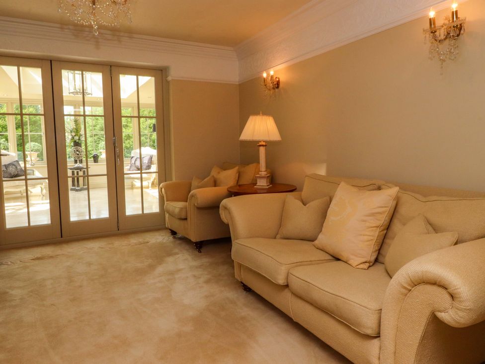 A living room with a sofa and sliding doors at Laithe House in Burnley