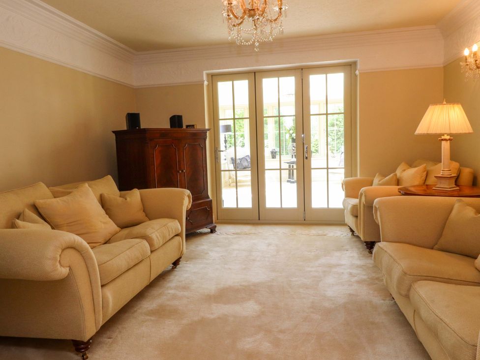 A living room with sofas and a lamp at Laithe House in Burnley