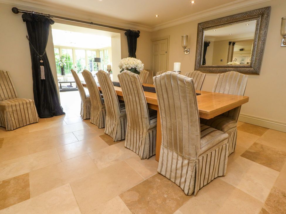A dining room with a wooden table and chairs at Laithe House in Burnley