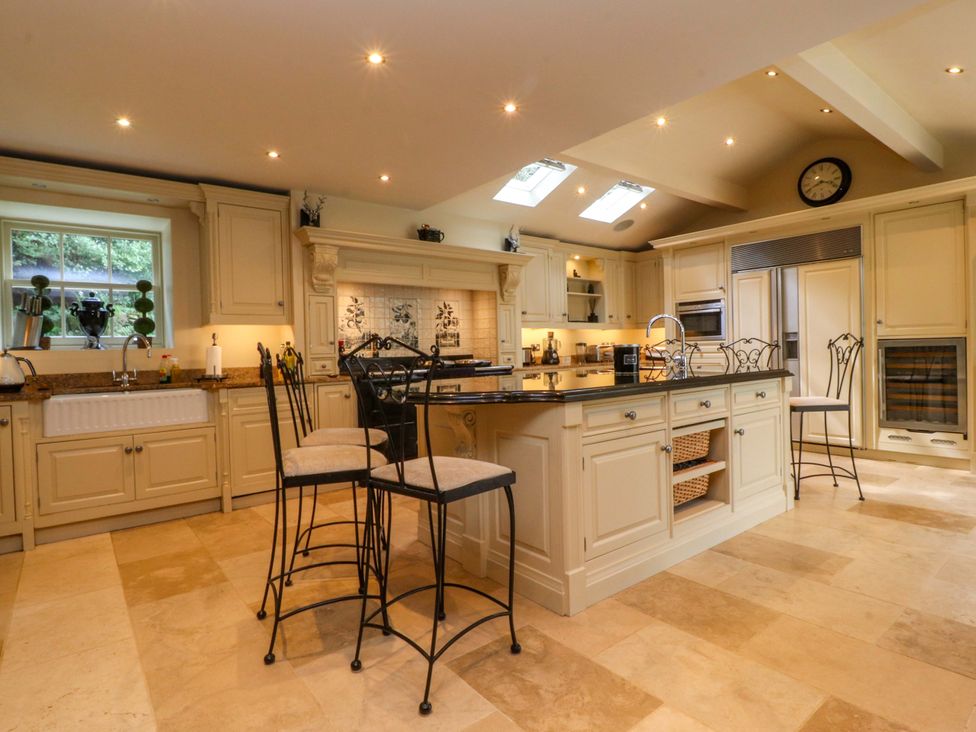 A kitchen with cabinets and an island at Laithe House Burnley