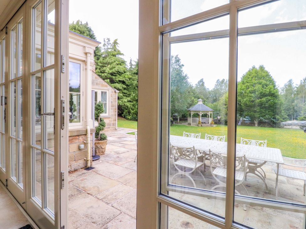 A view of a garden with a gazebo and outdoor furniture at Laithe House in Burnley