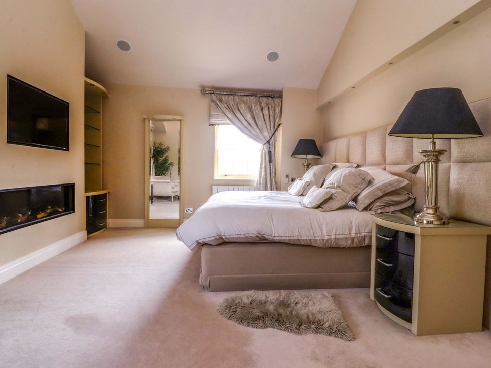 A bedroom with a bed and nightstand at Laithe House in Burnley