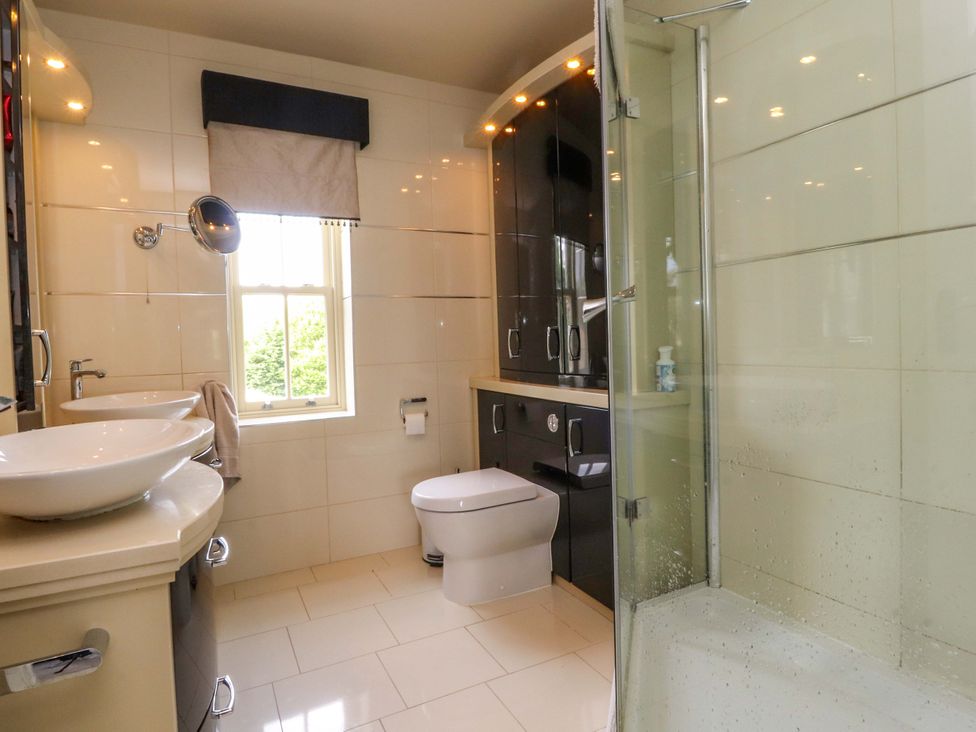 A bathroom with sink, toilet and shower at Laithe House in Burnley