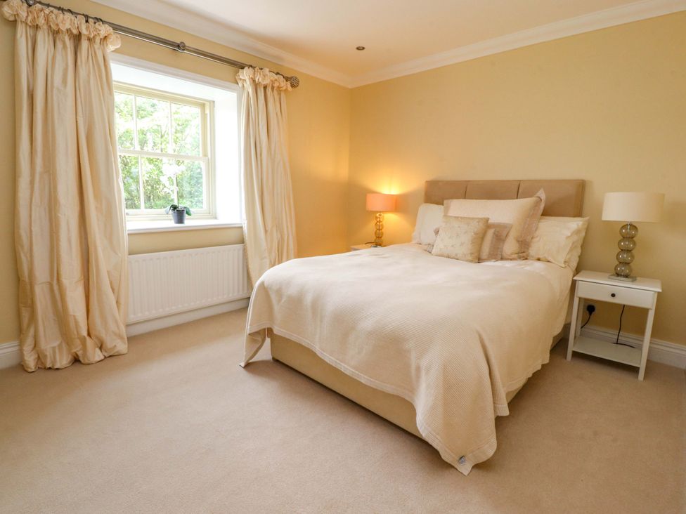 A bedroom with a bed and a window at Laithe House in Burnley
