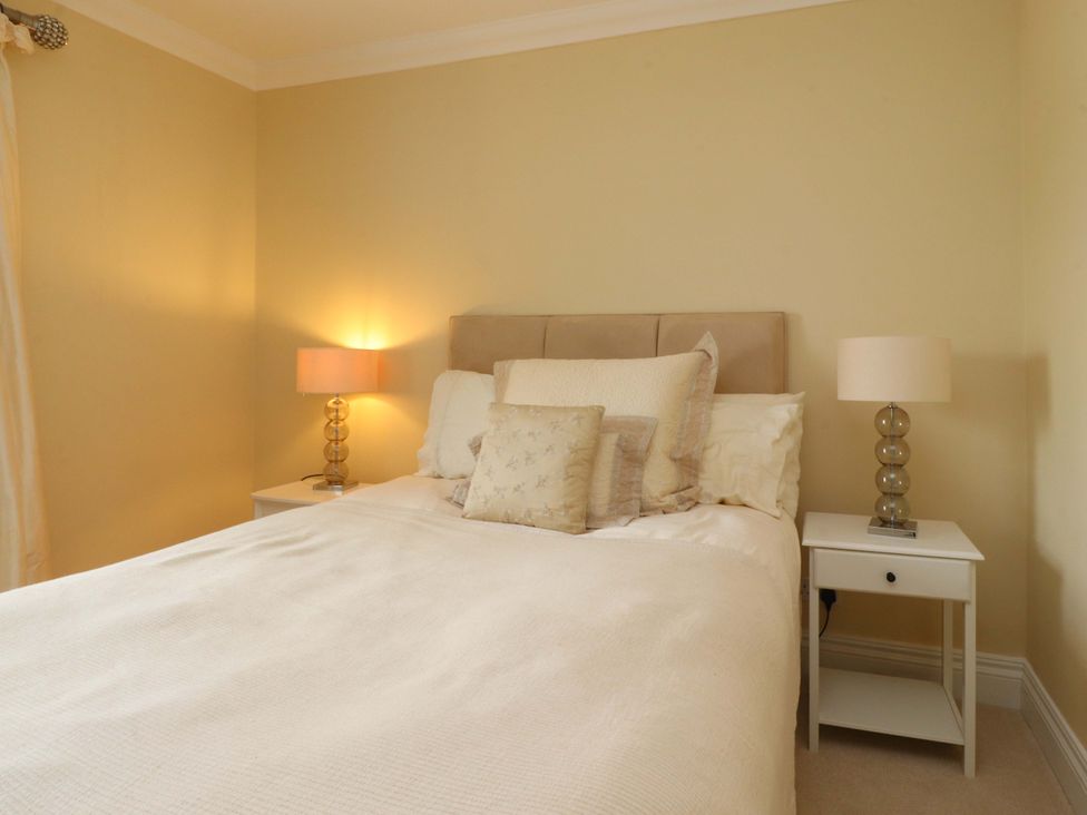 A bedroom with a bed and bedside tables at Laithe House in Burnley