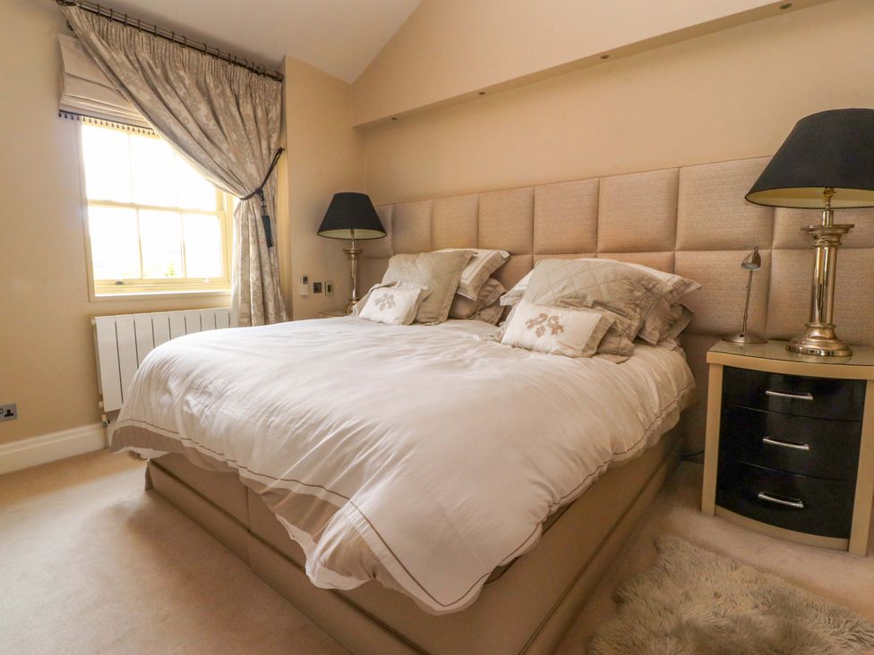 A bedroom with a bed and lamp at Laithe House in Burnley