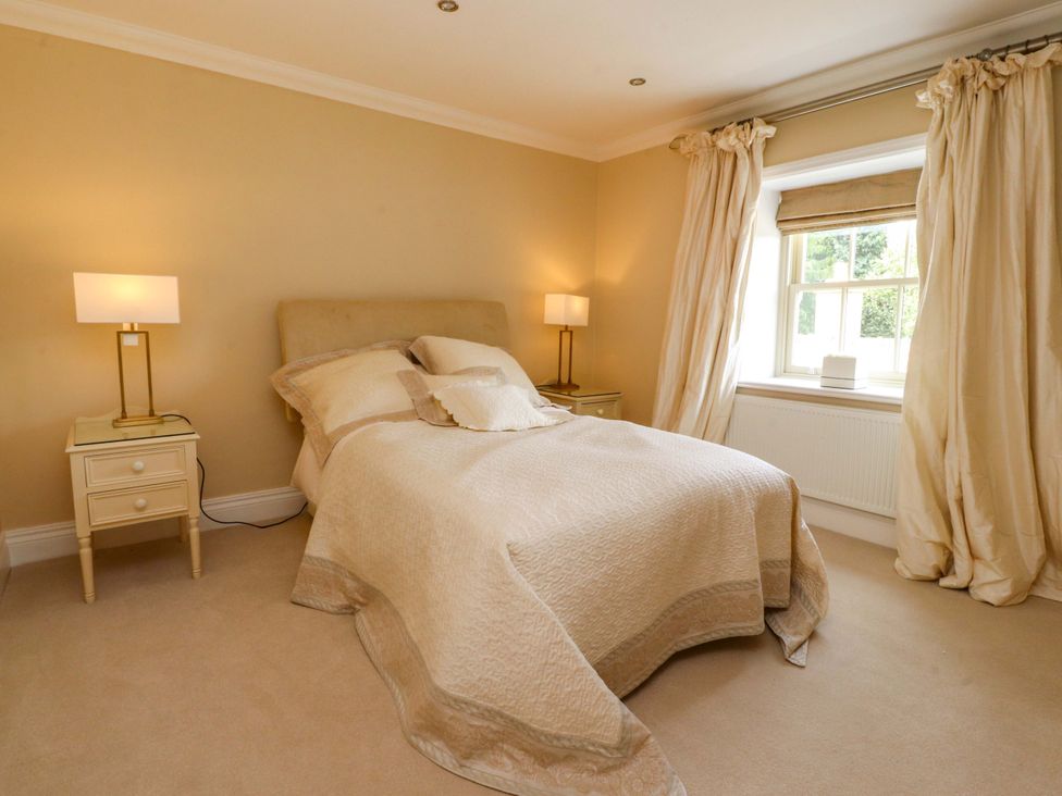 A bedroom with a bed and nightstand at Laithe House in Burnley