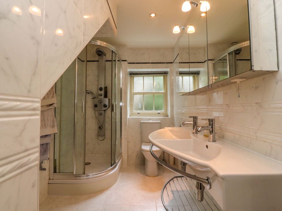 A bathroom featuring a shower, toilet, and sink at Laithe House in Burnley