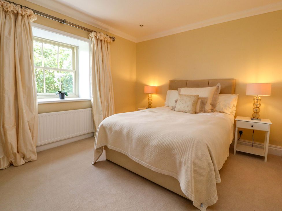 A bedroom with a bed and bedside tables at Laithe House in Burnley