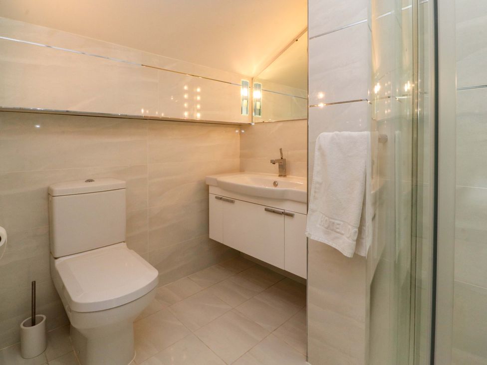 A bathroom with a sink and a shower at Laithe House in Burnley